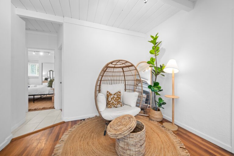 Casa Brisa living room with rattan chair and plant