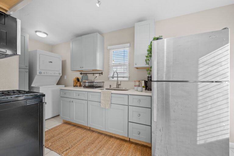 Casa Sol kitchen with white cabinets and full-size fridge