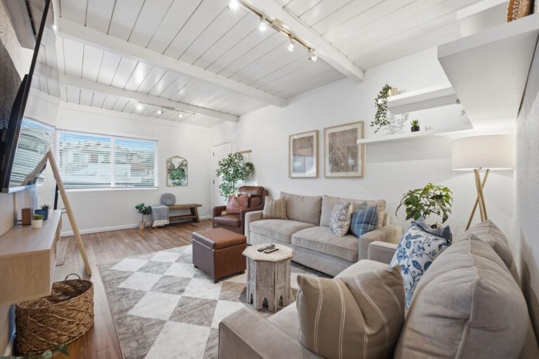 Casa Sol living room with green sofa and 75-inch smart TV