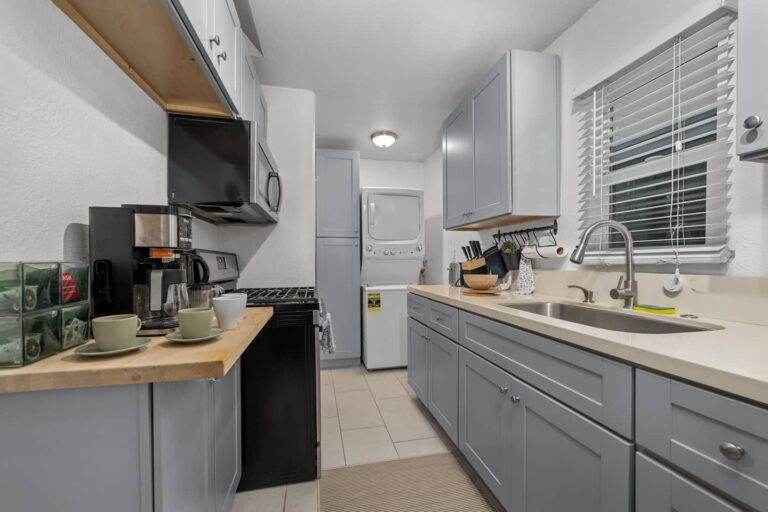 Casa Palma kitchen with 5-burner gas stove, washer and dryer, and Keurig